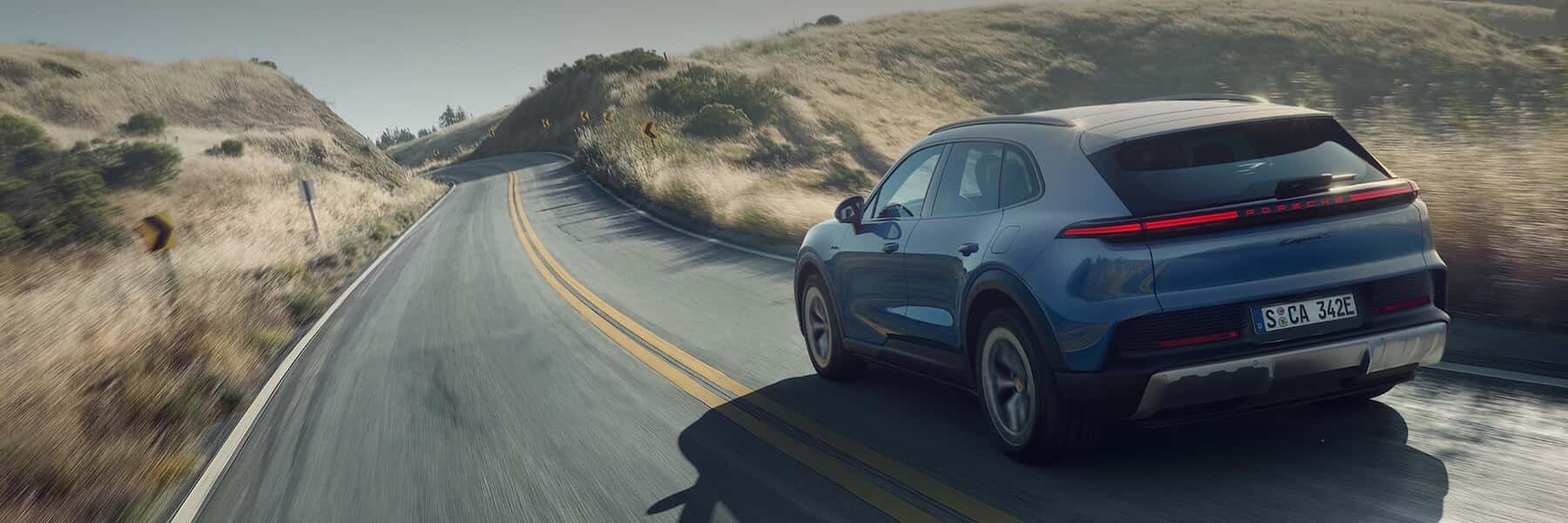 Porsche Cayenne Electric driving down a road