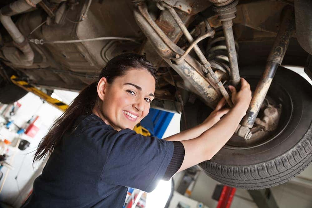 Female mechanic working on a vehicle