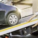 Car Loaded Onto A Recovery Truck For Transportation Champion Auto Group