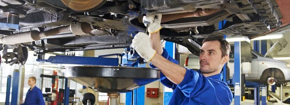 auto mechanic at car suspension repair work
