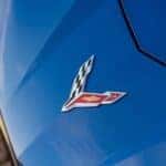 A close up shows the front emblem on a blue 2021 Chevy Corvette.