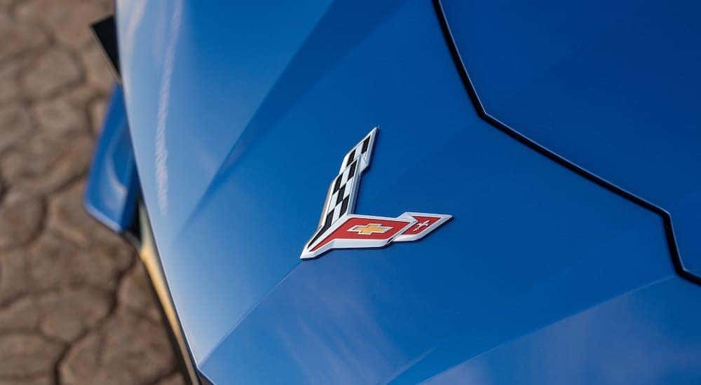 A close up shows the front emblem on a blue 2021 Chevy Corvette.