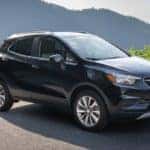 A black 2021 Buick Encore is parked in front of a mountain lookout.