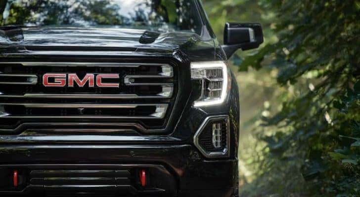 A black 2021 GMC Sierra 1500 is shown in closeup from the front after leaving a Louisville GMC dealer.