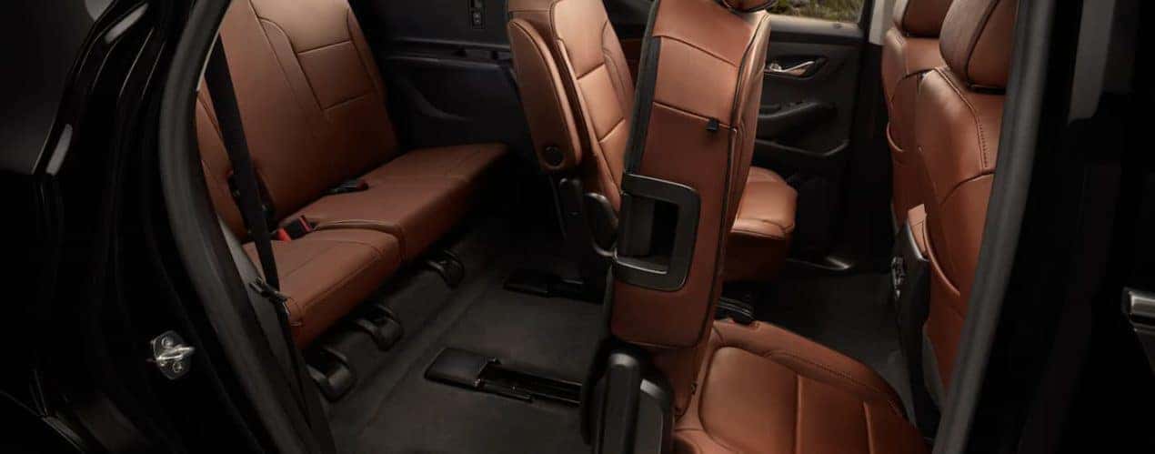 The brown interior is shown from the passenger side in a 2021 Chevy Traverse.