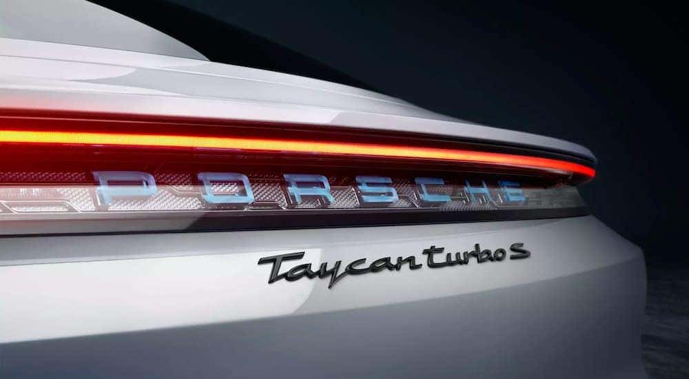 A close up shows the rear badging on a silver 2021 Porsche Taycan Turbo S