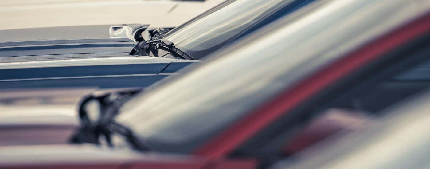 A row of cars are shown at a Louisville used GMC dealer.