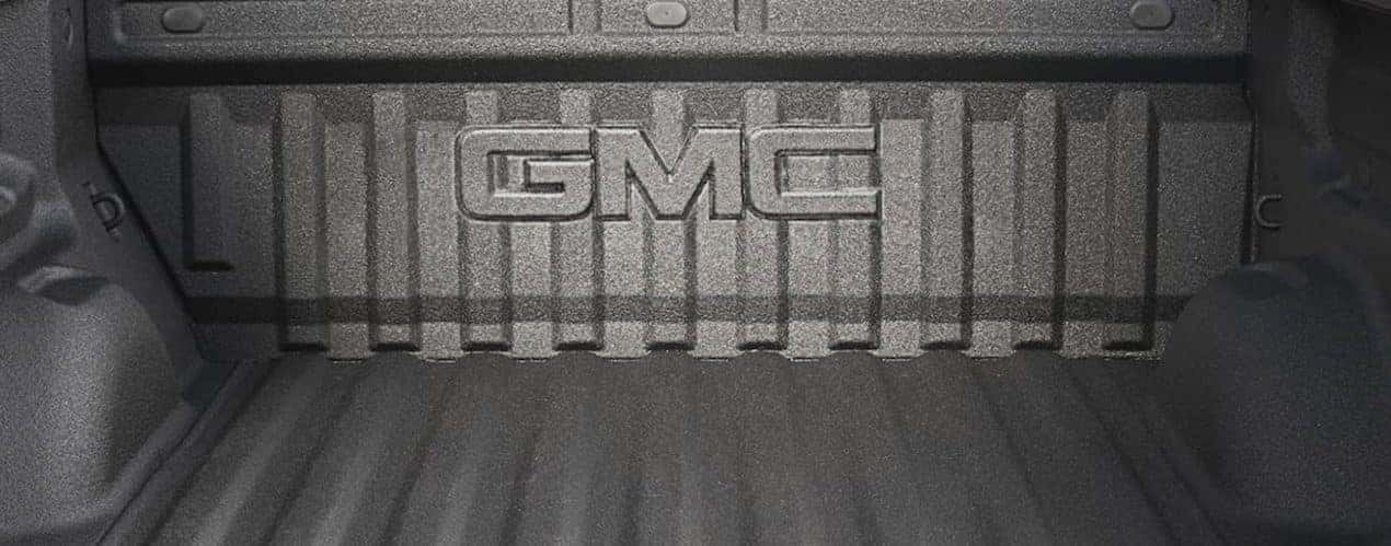 The grey bed of a 2022 GMC Canyon is shown in a close up.