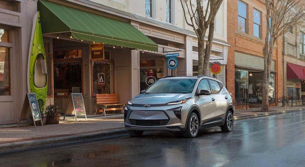 A silver 2022 Chevy Bolt EUV is shown parked on a city street near a Louisville Chevy dealer.