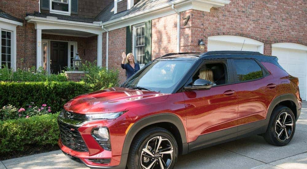 A teen driver is shown leaving home driving a red 2021 Chevy Trailblazer.