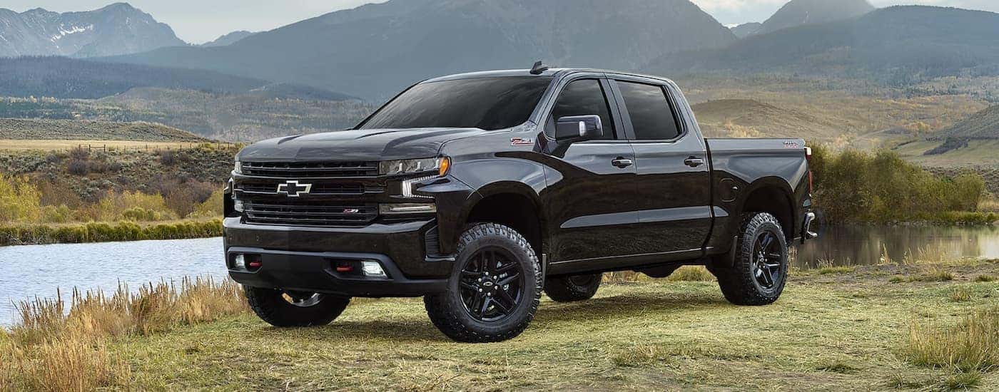 A black 2022 Chevy Silverado 1500 Z71 is shown parked next to a lake after leaving a Louisville truck dealership.