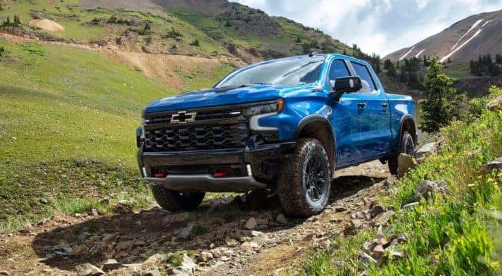 A blue 2022 Chevy Silverado 1500 ZR2 is shown parked on a rocky path.
