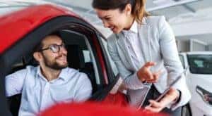 A saleswoman is shown speaking to a customer at a Clarksville, IN Chevrolet dealership.