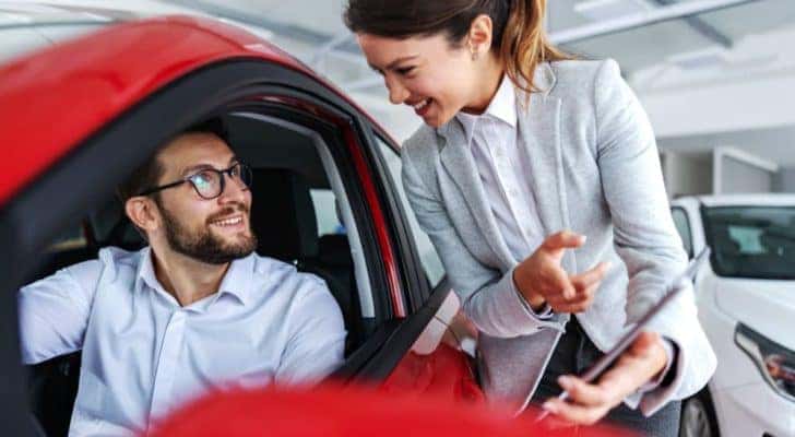 A saleswoman is shown speaking to a customer at a Clarksville, IN Chevrolet dealership.