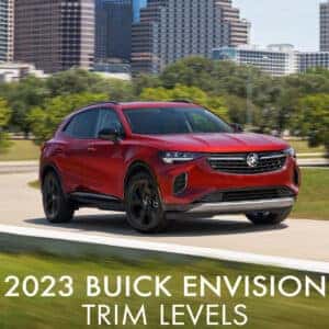2023 Buick Envision with Sport Touring Package Driving with City Backdrop