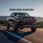2024 GMC Canyon Driving in Desert with "2024 GMC Canyon" Text Above