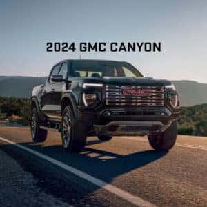 2024 GMC Canyon Driving in Desert with "2024 GMC Canyon" Text Above