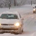 Two Cars Driving in Snow