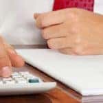 Businessman with a calculator. calculation of costs, revenue, balance sheet