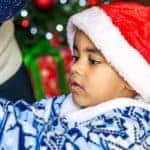 Young Boy in Santa Hat with Christmas Decorations