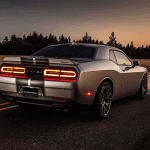 Challenger SRT® 392 features a body-color spoiler and dual rear exhaust with bright tips. Shown in Billet Silver Metallic with the available twin black center stripes.