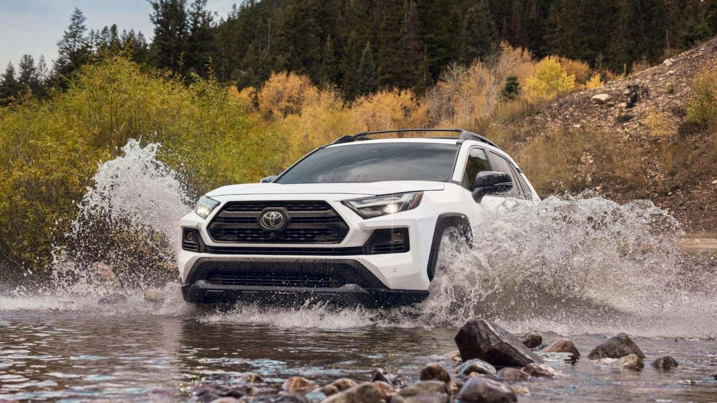 white toyota rav4 driving through water