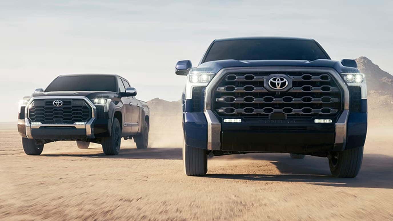 Two 2026 Toyota Tundra trucks racing in the desert
