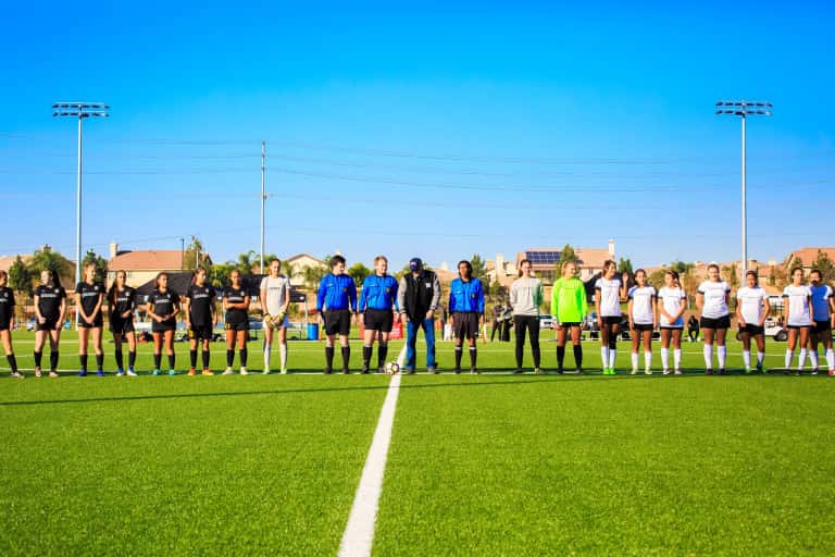 two teams of girls lining up before the soccer game