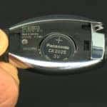 Closeup of opened Mercedes-Benz key fob and battery