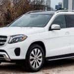White Mercedes-Benz GLS with city skyline in background