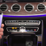 Hand holding an Android phone getting ready to be paired with Mercedes-Benz system