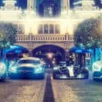 Mercedes-AMG racing vehicles parked in a row on cobblestone street at night with headlights on