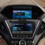 View of 2020 Acura MDX dashboard with center console and road in background