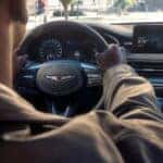 Person behind the wheel of the 2026 Genesis G70