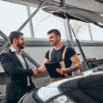 Genesis service technician speaking with a customer