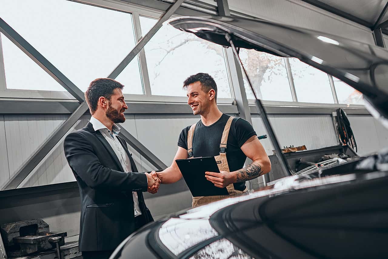 Genesis service technician speaking with a customer