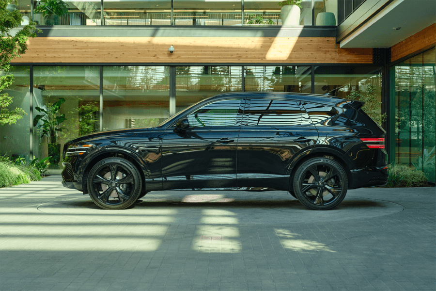 2026 Genesis GV80parked outside of modern home.
