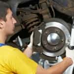 auto mechanic at car suspension repair work