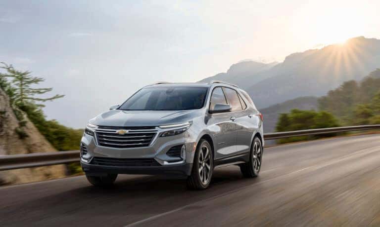 2024 Chevrolet Equinox exterior driving through sunny hills