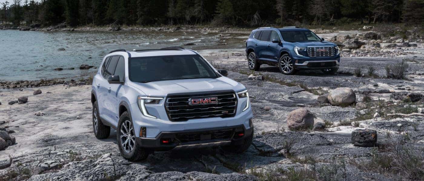 2024 GMC Acadia exterior two side by side on rocky beach
