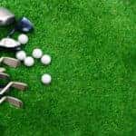 Golf Bag with Balls and Tees Laying on Grass