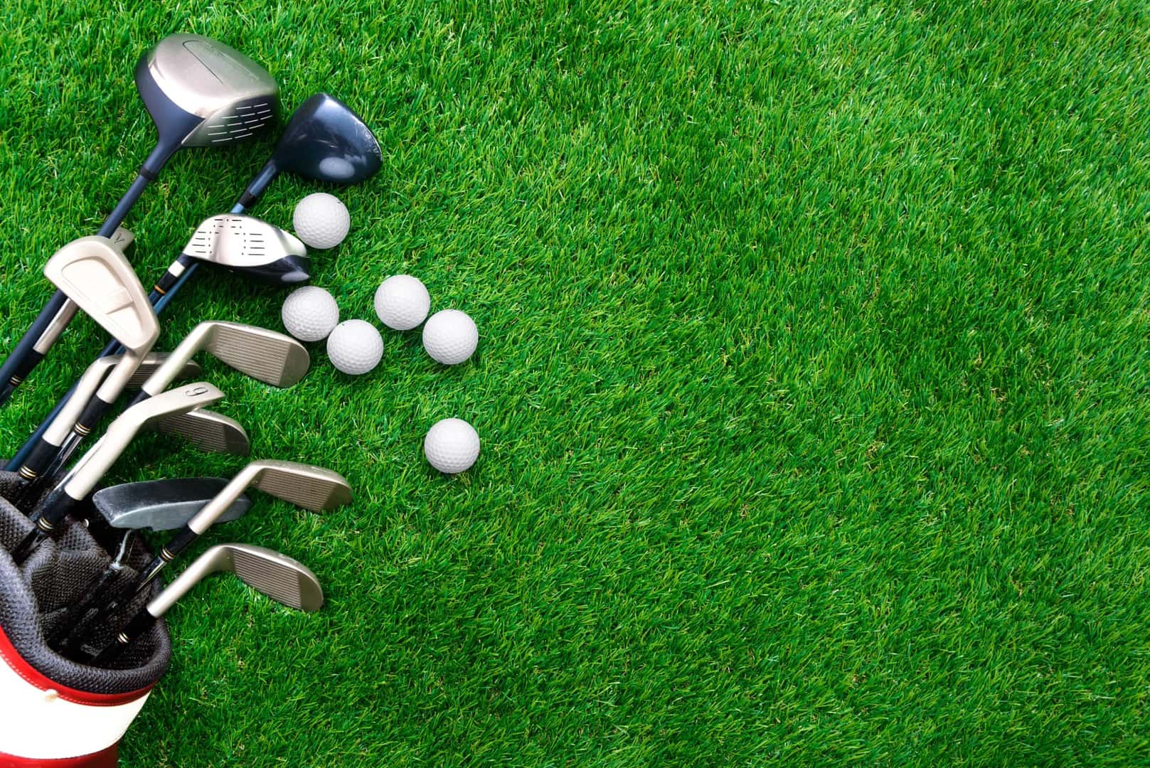 Golf Bag with Balls and Tees Laying on Grass