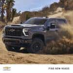 2024 Chevrolet Silverado 2500HD driving off-road in a sandy desert