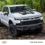 2024 Chevy Silverado 1500 driving through a forest