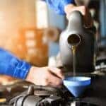 a mechanic changing the oil of a car