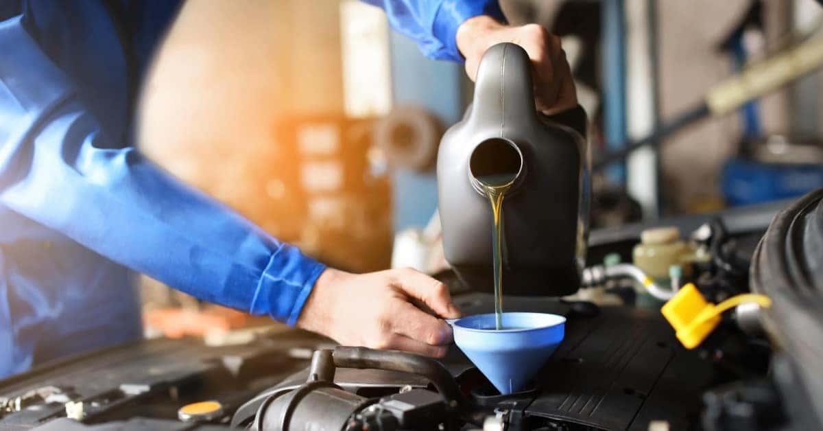 a mechanic changing the oil of a car