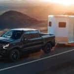 2025 Chevy Silverado 1500 hauling a trailer on the road