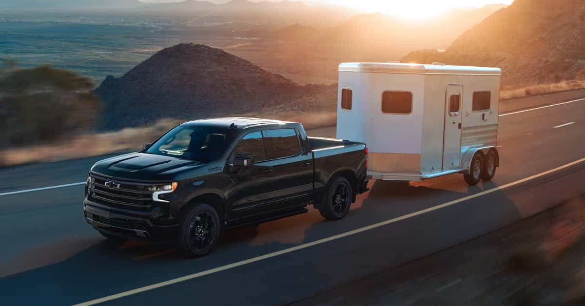 2025 Chevy Silverado 1500 hauling a trailer on the road