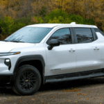 A white 2025 Chevy Silverado EV parked on the side of a street