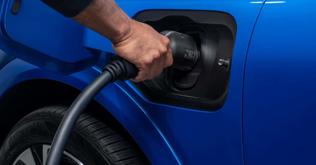 A man charging a Chevy EV